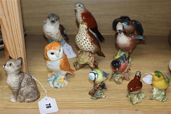 A Beswick seated cat and ten models of birds,